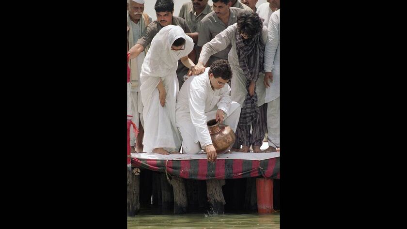 1991, Αλαχαμπάντ, Ινδία. Ο Ραχούλ Γκάντι ρίχνει τις στάχτες του πατέρα του, Ρατζίβ Γκάντι, στον ποταμό Γάγγη. Δίπλα του η μητέρα του και η αδελφή του. Ο Γκάντι σκοτώθηκε σε έκρηξη βόμβας κατά τη διάρκεια της προεκλογικής του εκστρατείας.